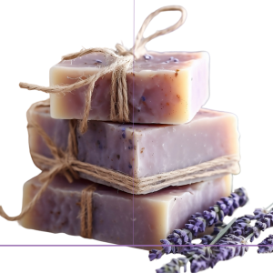 A Stack of 3 bars of purple Soap with a rope tied with a bow and lavender beside it